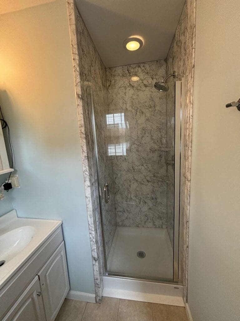 walk-in shower with spotlight light fixture