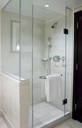 a bathroom with a walk-in shower next to a sink