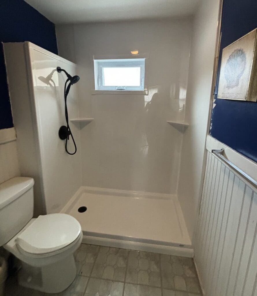 bathroom with walk-in shower that has a window for natural light