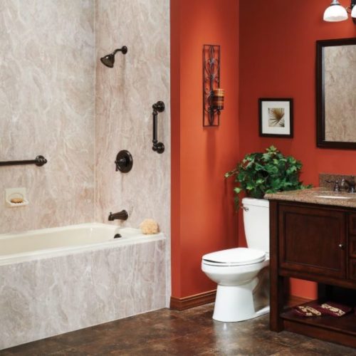 Vibrant orange bathroom transformed by Carefree Home Pros, experts in bathtub replacement services for a fresh and modern look.